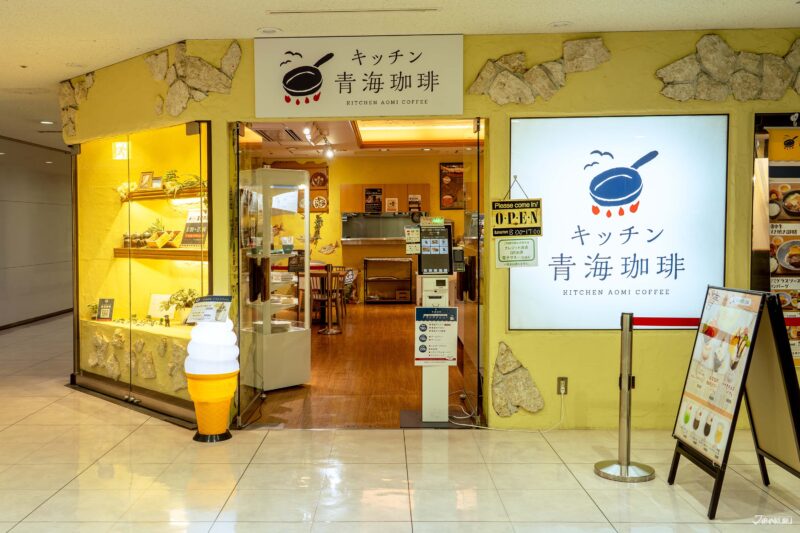 บริเวณด้านหน้าร้าน Kitchen Aomi Coffee ตกแต่งสีเหลืองครีม ดูอบอุ่น